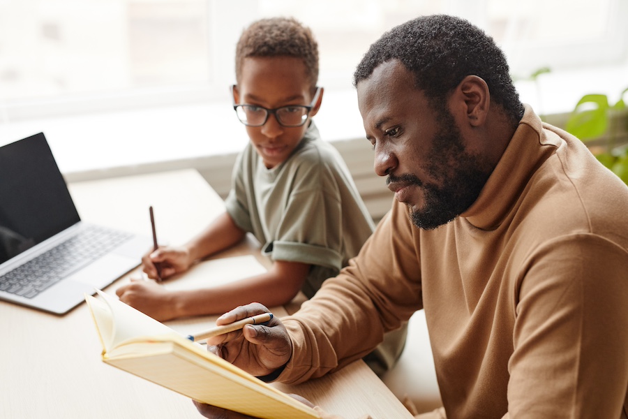 Single dad helping his tween child with homework.