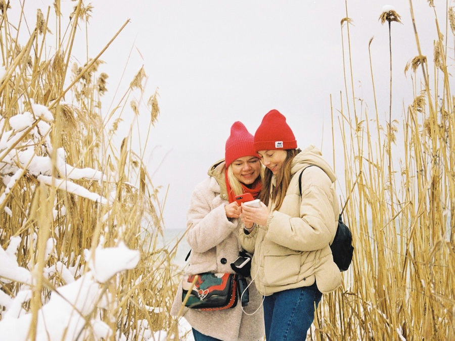 Single mother and daughter sharing a happy winter moment outdoors